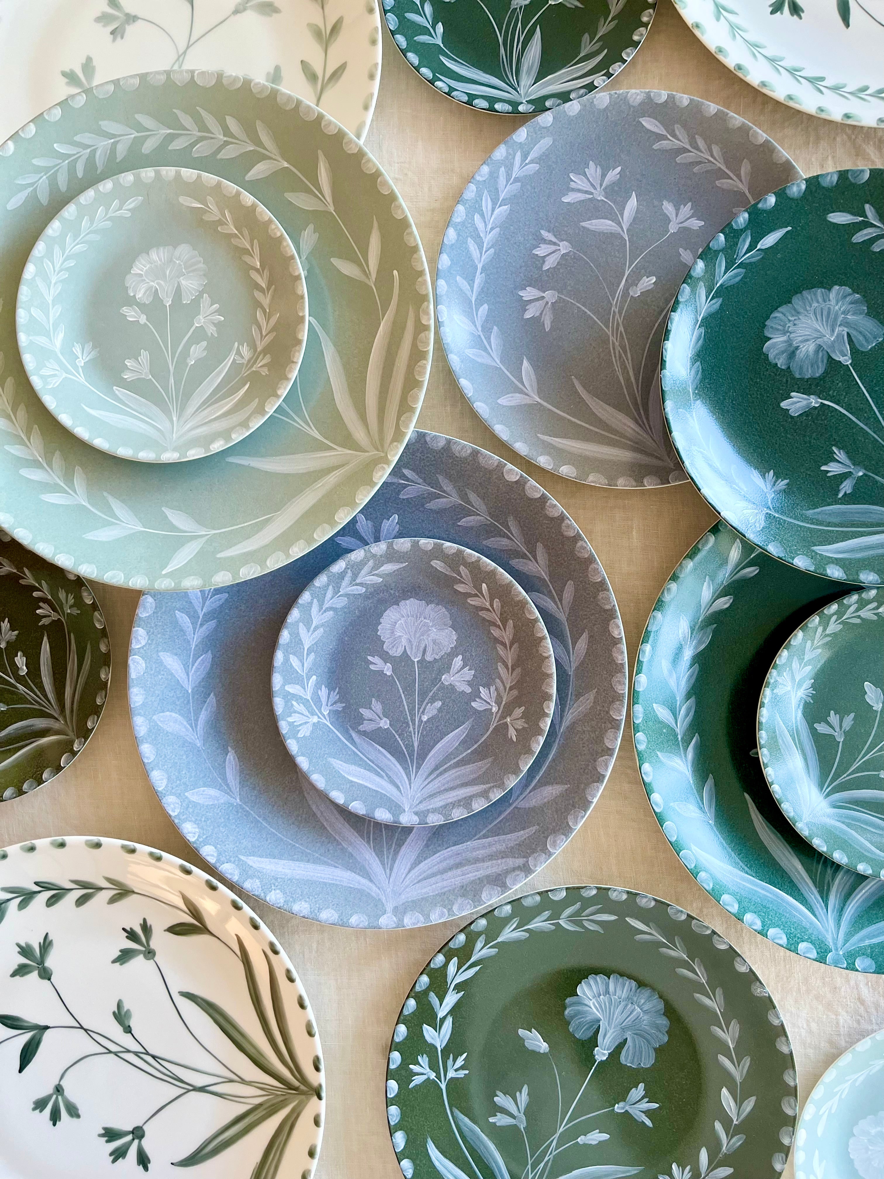 blue bread plate with white floral pattern with dinner plates