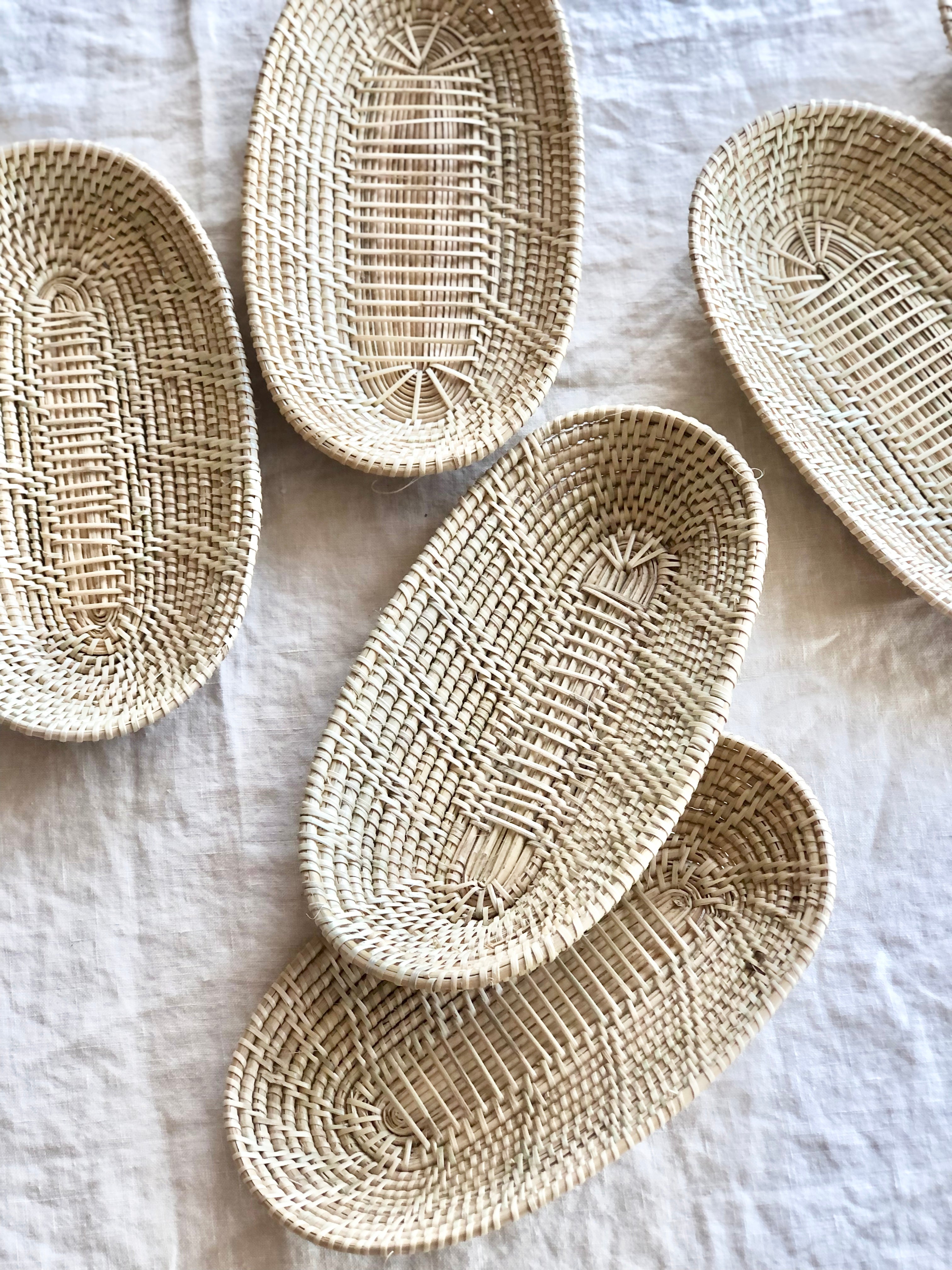 little woven oval baskets assorted layout on a white table cloth