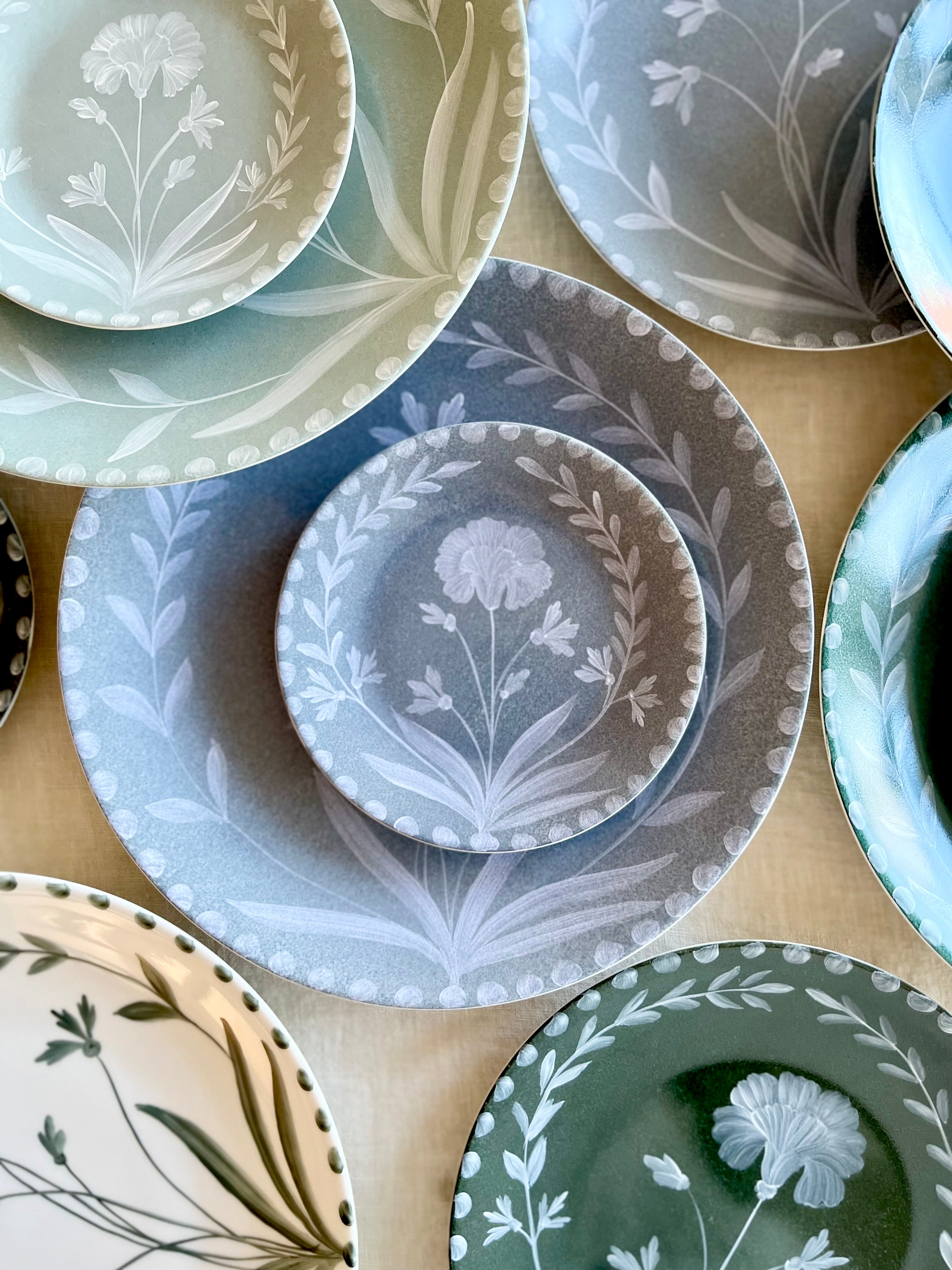 blue dinner plate with white floral pattern detail view