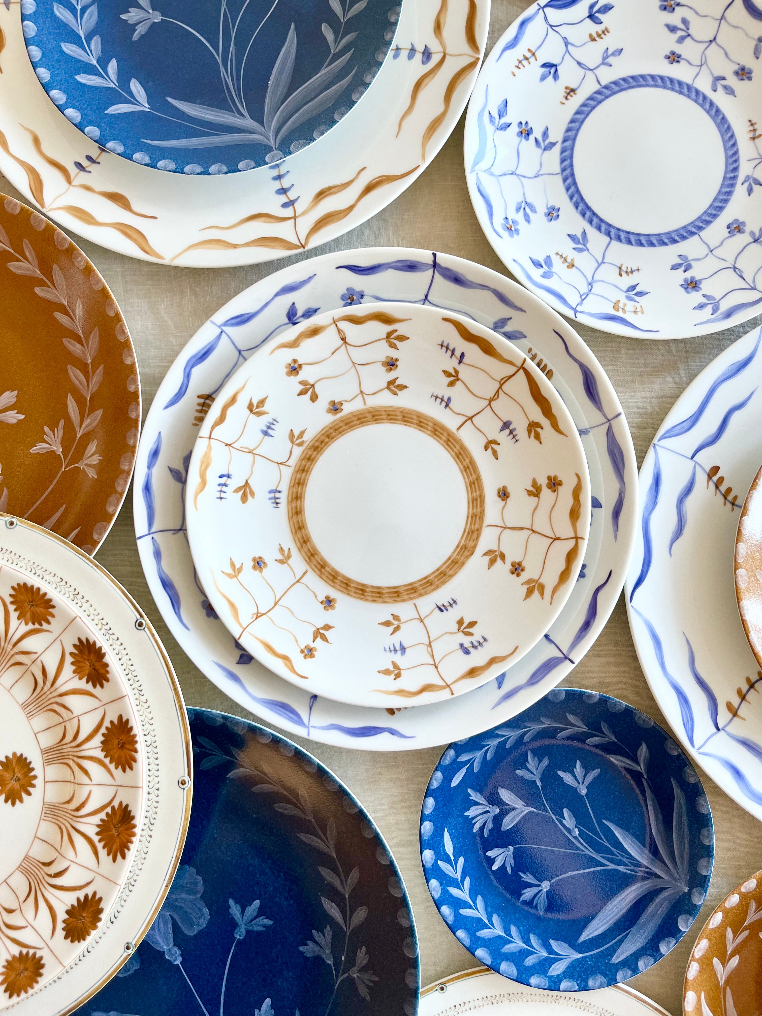 blue salad plate with hand painted white floral design on dinner plate