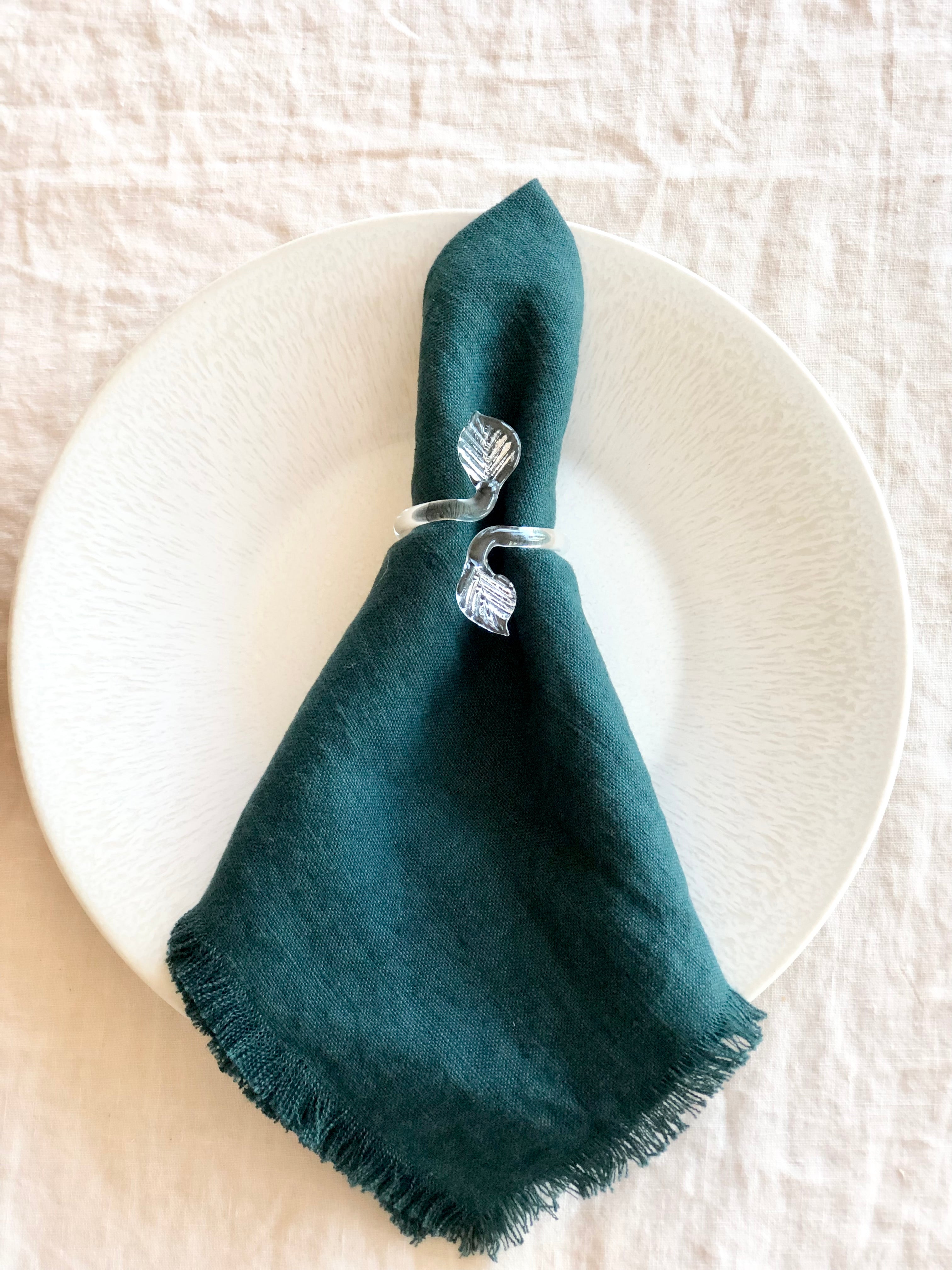 clear glass napkin rings with folded napkin