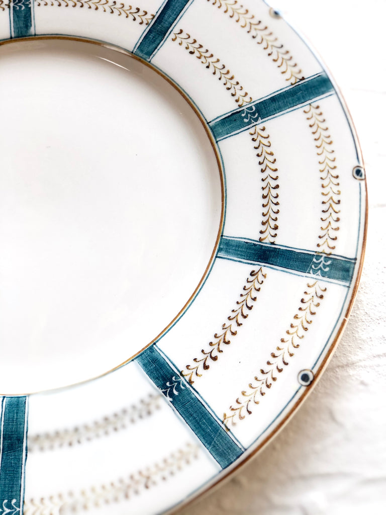 ceramic dinner plate with teal stripes around edge detail view