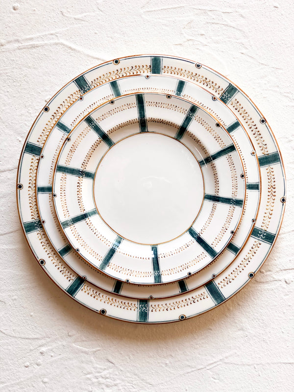 ceramic dinner plate with teal stripes around edge with charger and salad plate
