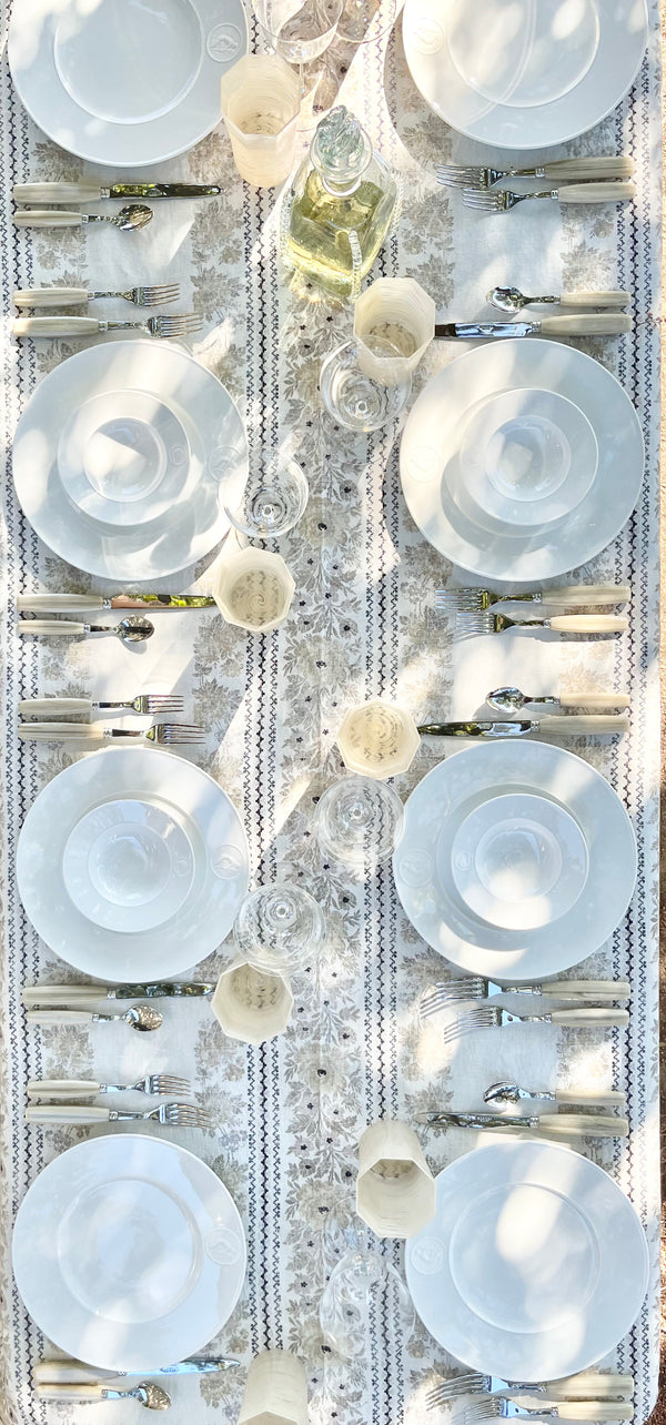 white salad plate with greek medallion design in tablescape top view