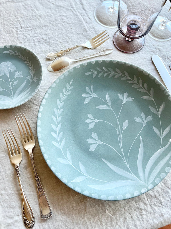 sage green limoges porecelain dinner plate with hand painted white floral design on white table
