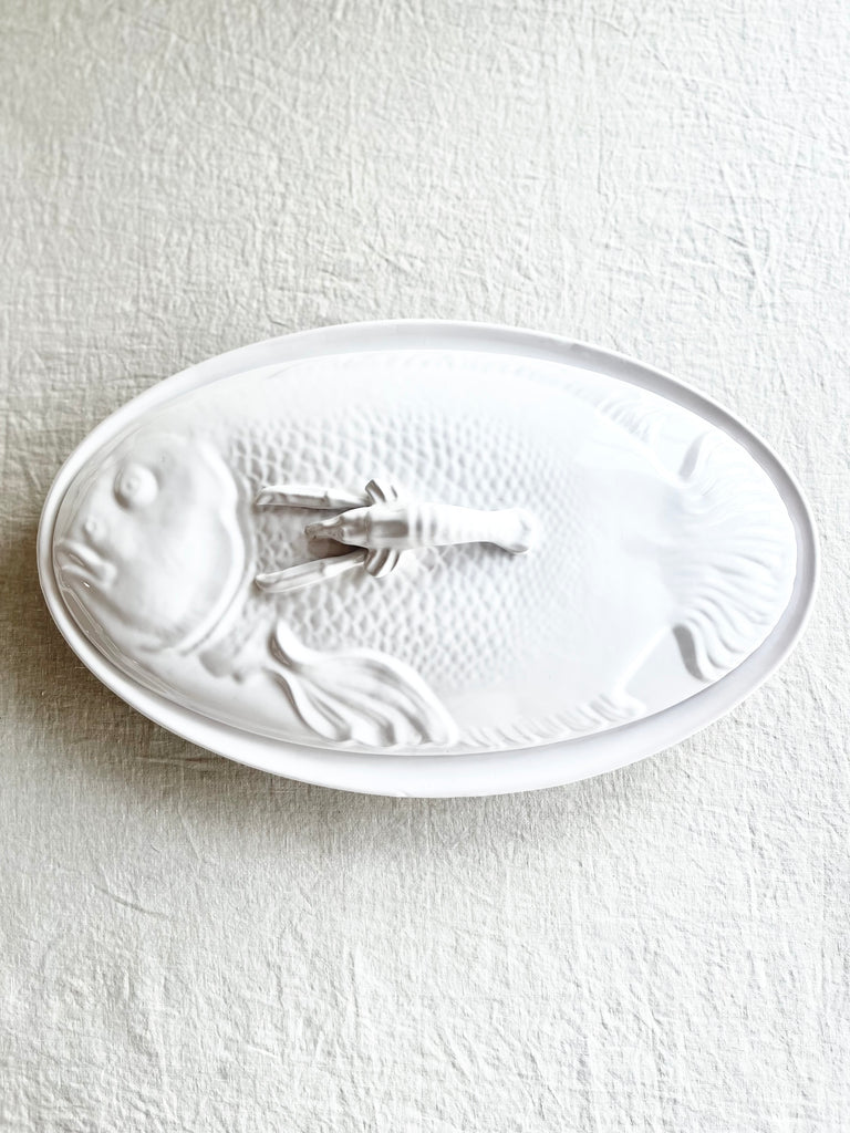 white oval large serving platter with fish patterned cover