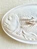 white oval large serving platter with fish patterned cover detail view