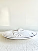 white oval large serving platter with fish patterned cover side view