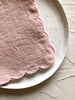 pink Scalloped Peony Napkins staked on a plate