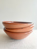 large pasta bowl with radial leaf design portocale color stacked side view
