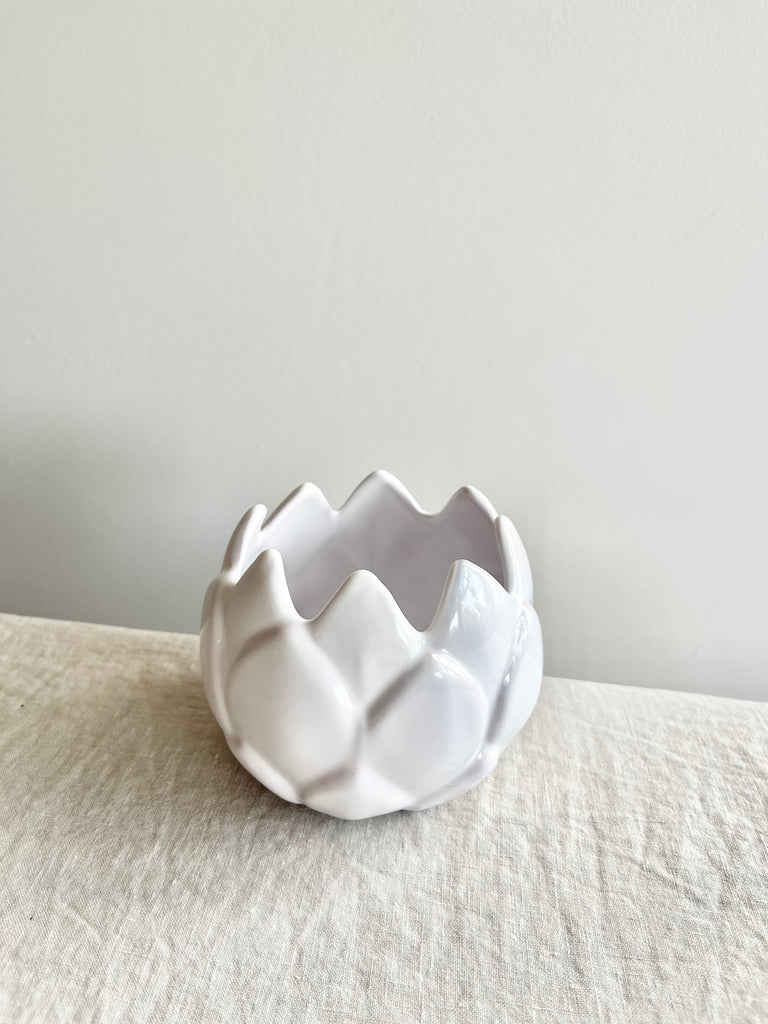 white artichoke candle holder on white table top view