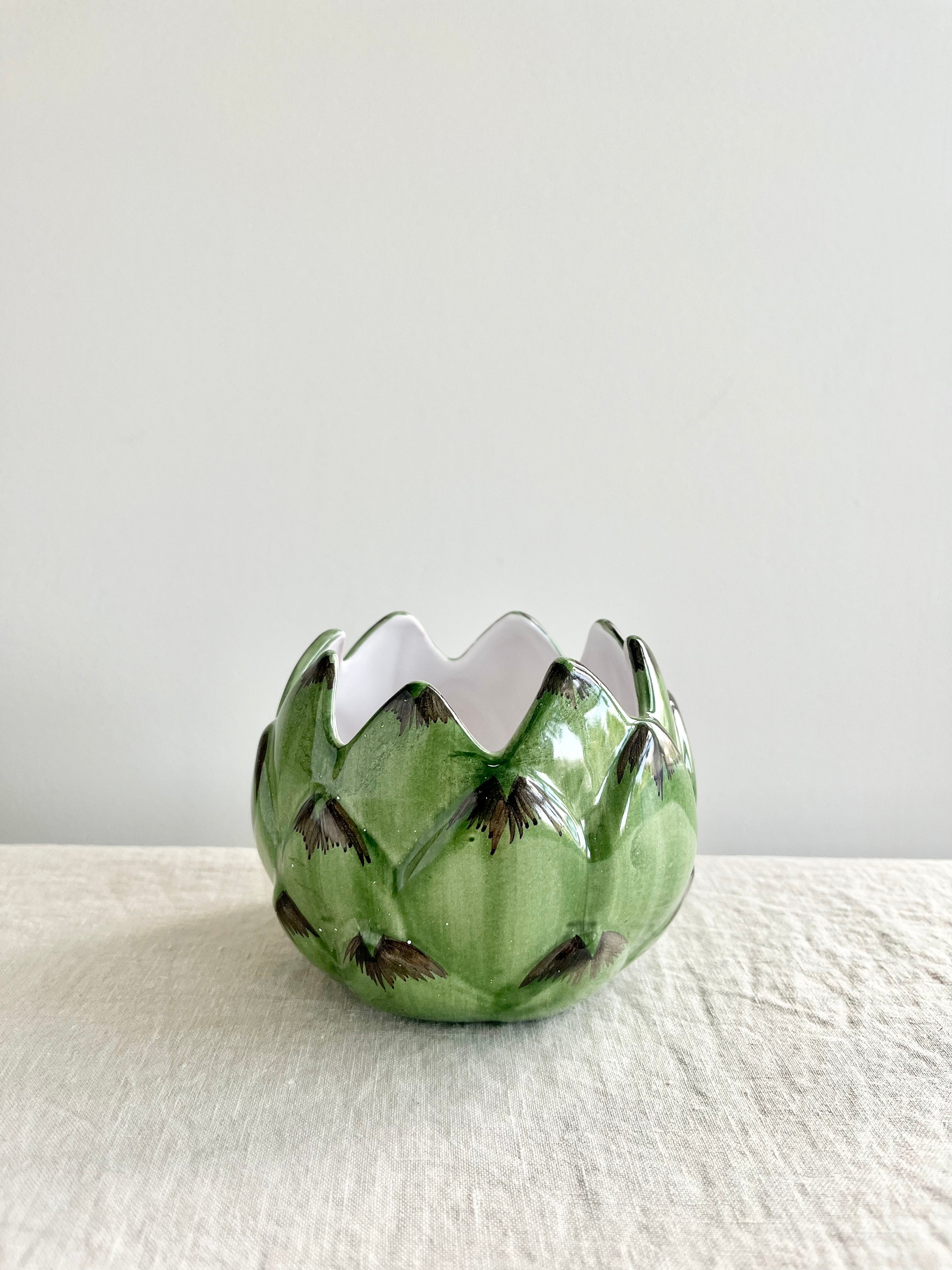 artichoke candle holder on white table