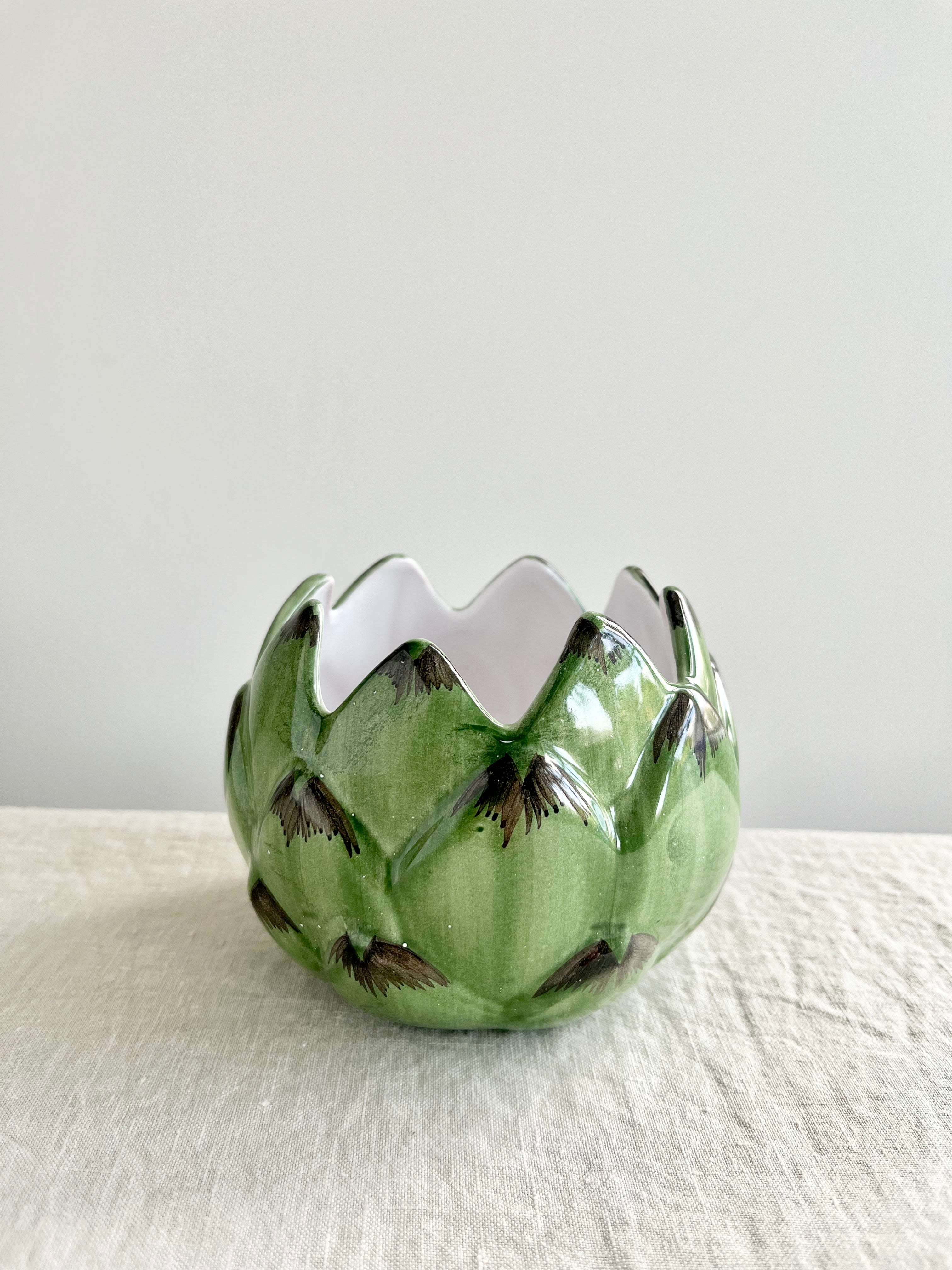 artichoke candle holder on linen table cloth