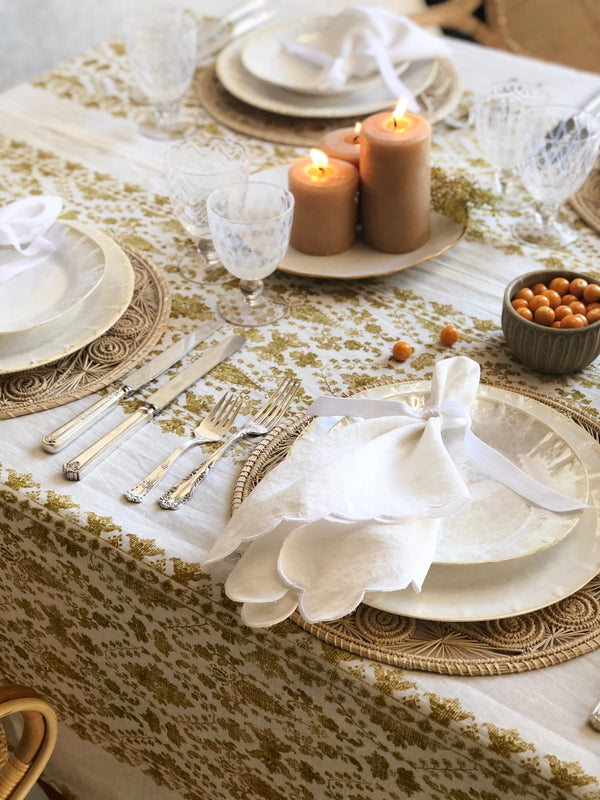 white linen linens with scalloped edge on placesetting