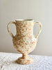 cream amphora vase with light brown speckle pattern 13 inches tall on white table