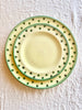 hand painted salad plate with green rim and dots around edge with dinner plate