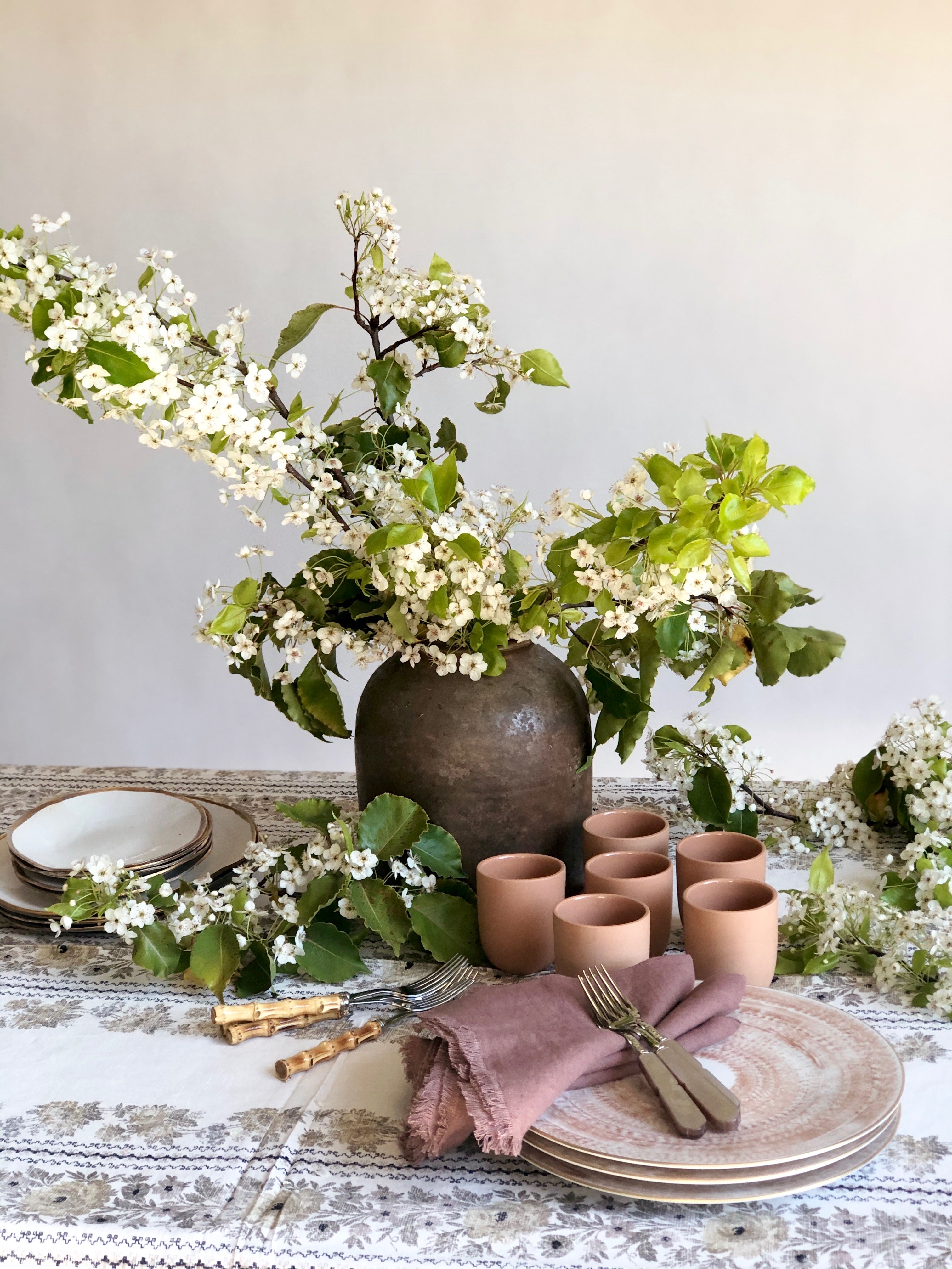 ablecloth in floral pattern by d'ascoli in taupe with vase of flowers