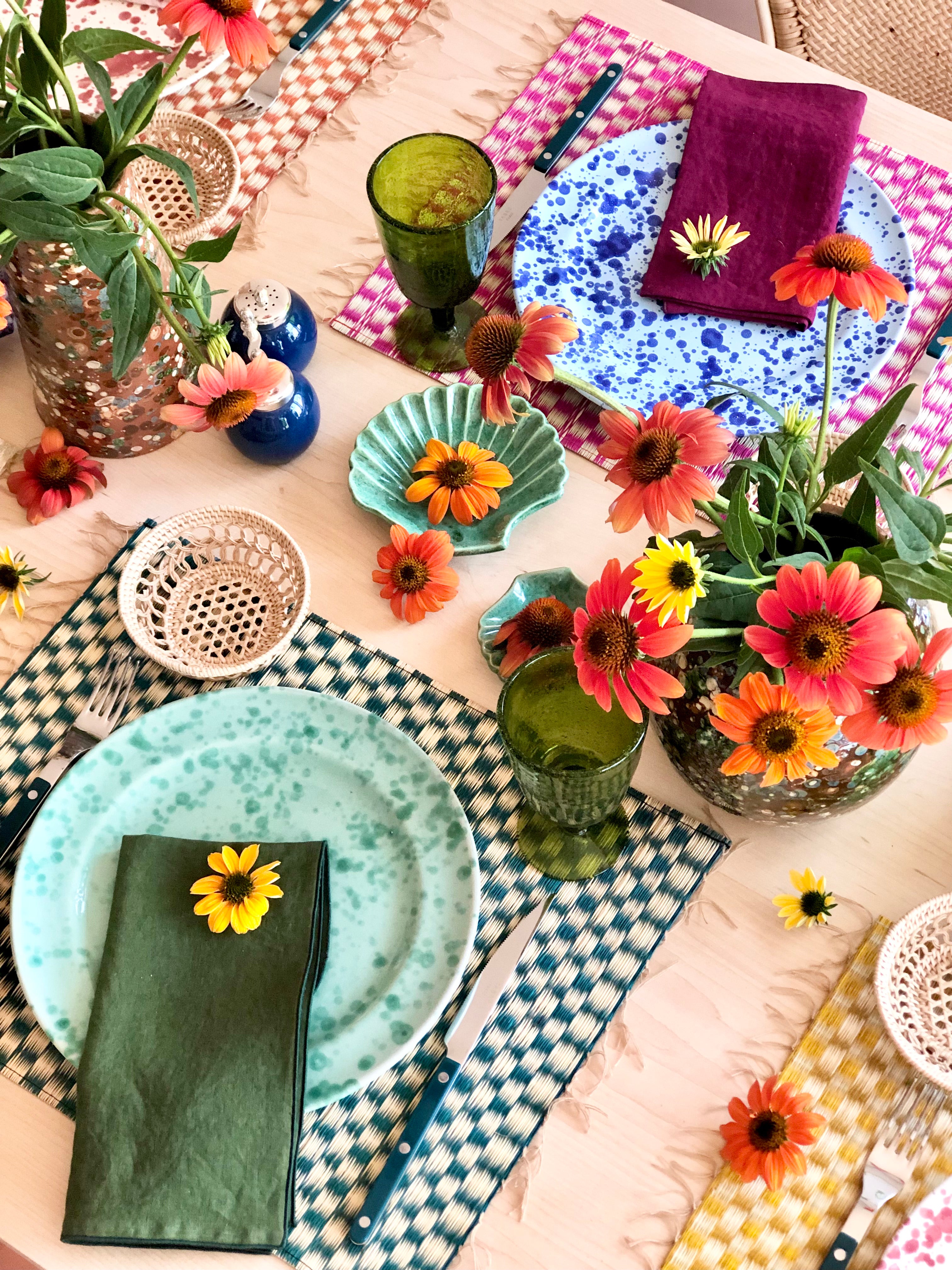 pink and white woven placemat with blue speckled plate