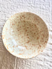 cream fasano serving bowl with light brown speckle pattern top view
