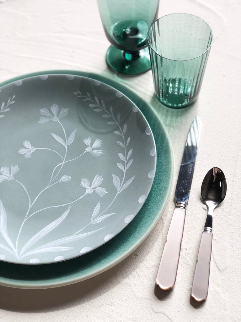 sage green limoges porecelain dinner plate with hand painted white floral design in placesetting