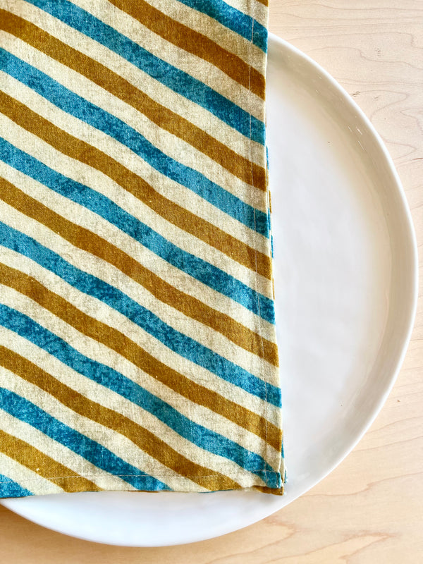 blue and gold cotton napkins 20 inch on a white plate