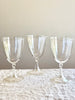 three clear opalescent wine glasses