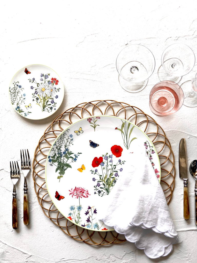 white porcelain charger plate with wildflowers on woven placemat