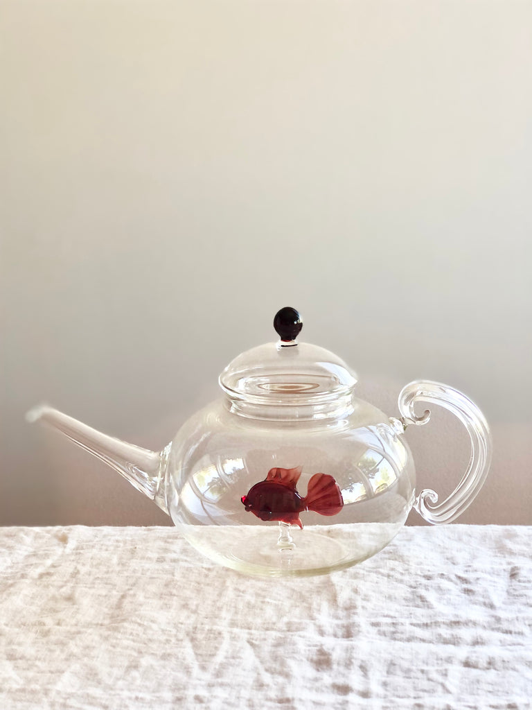 clear hand blown glass teapot with red glass fish in bottom