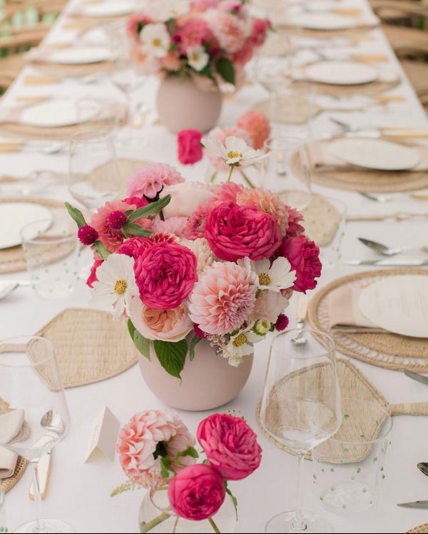 round placemat in tablescape with pink flowers