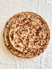 fasano charger with brown splatter pattern in place setting