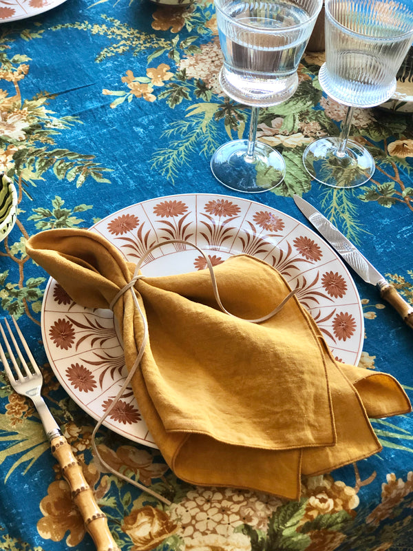 linen napkins 18 inch mustard color on blue floral table cloth