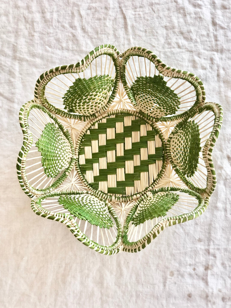 light brown and olive green round woven bread basket 8.5 inches in diameter top view