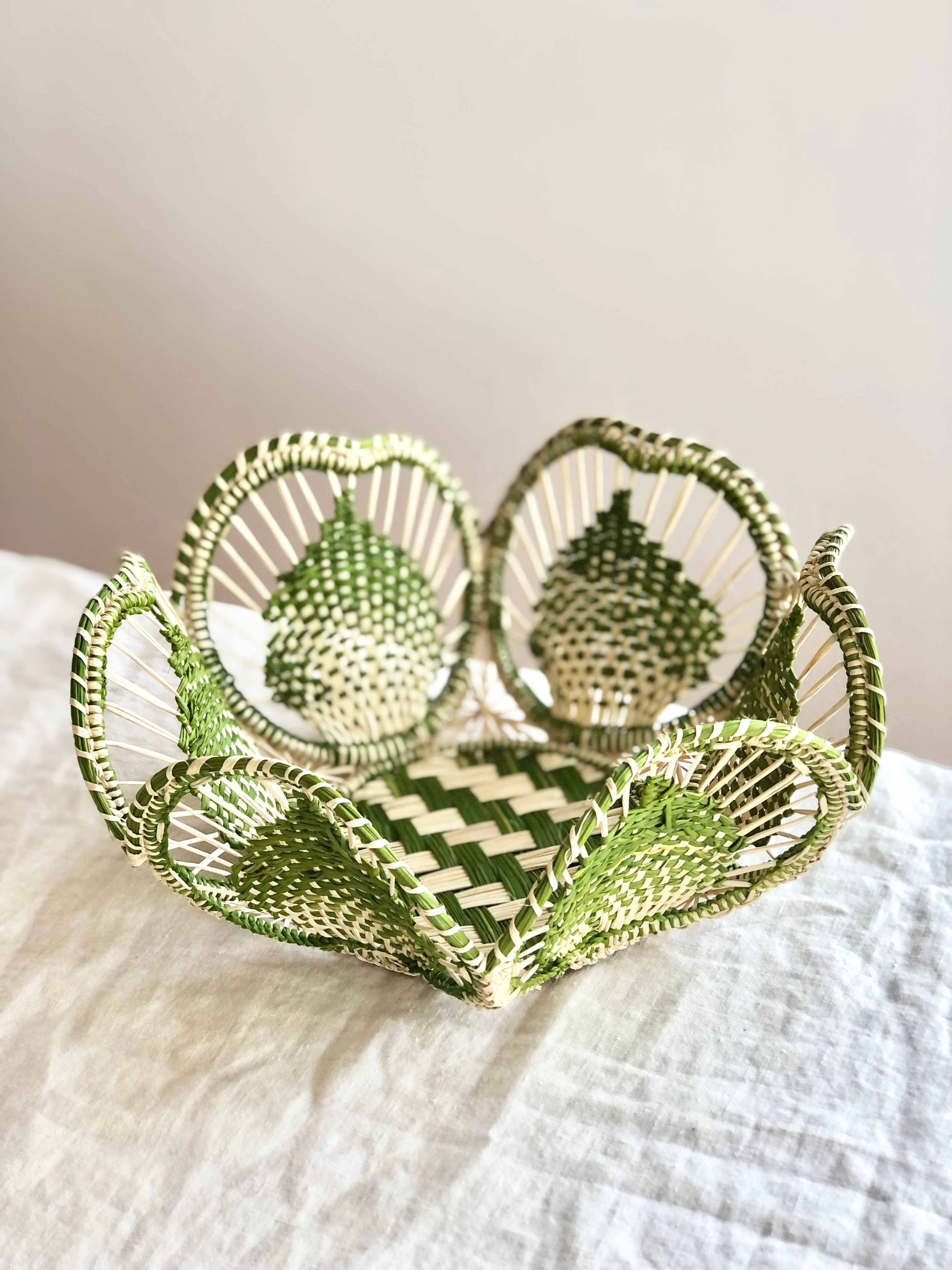 light brown and olive green round woven bread basket 8.5 inches in diameter