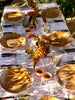 Umber toned brown dinner plates in outdoor table setting.