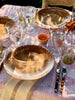 Umber toned brown dinner plate in table setting with glasses and silverware