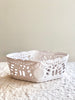 white ceramic bread basket made of french faience on white table