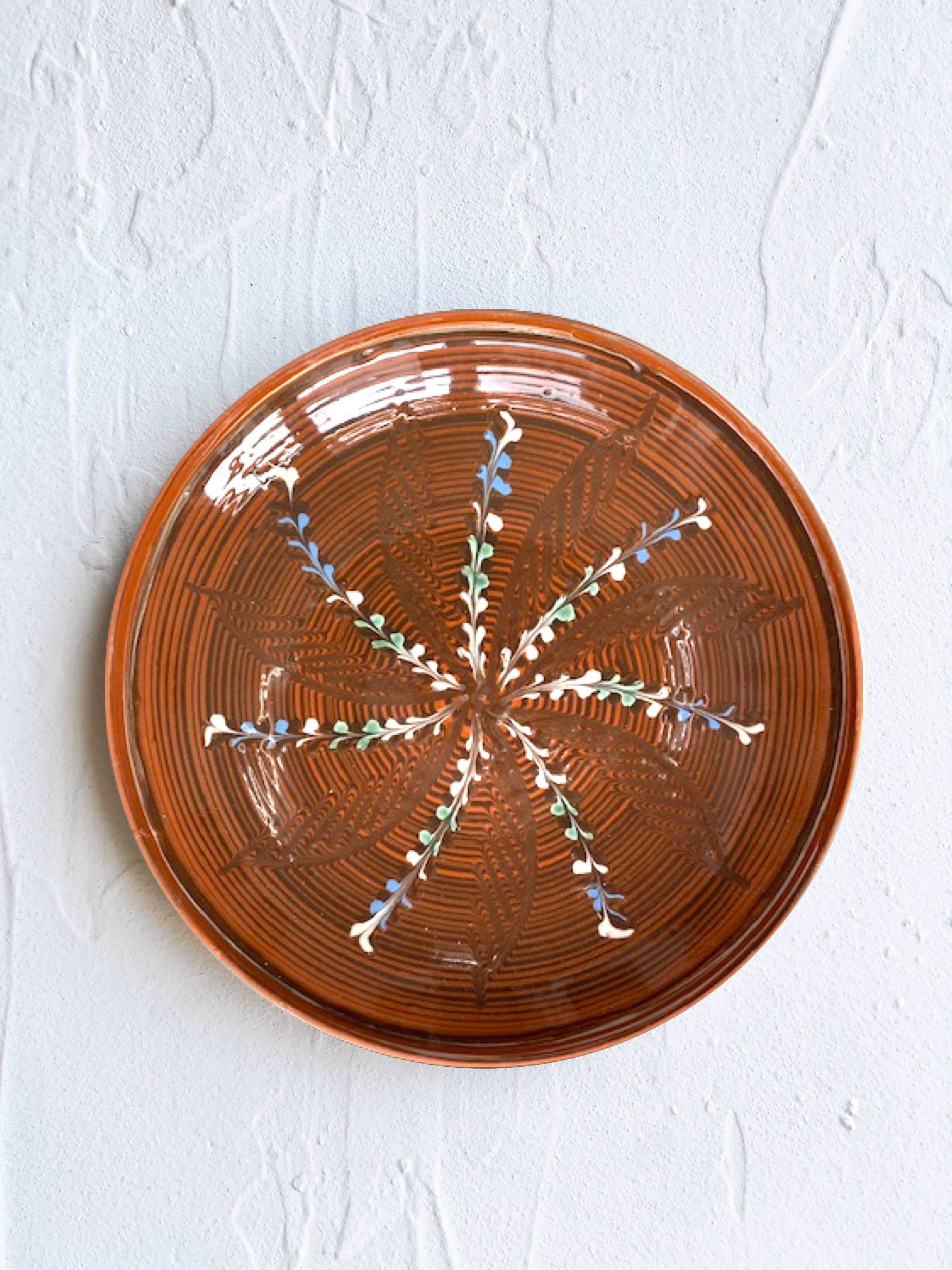 ceramic dinner plate in henna with radial leaf design