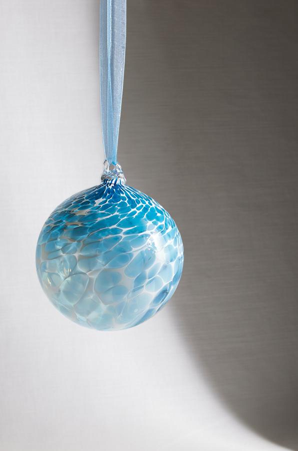 hand blown glass ornament blue and teal swirl pattern hanging from ribbon