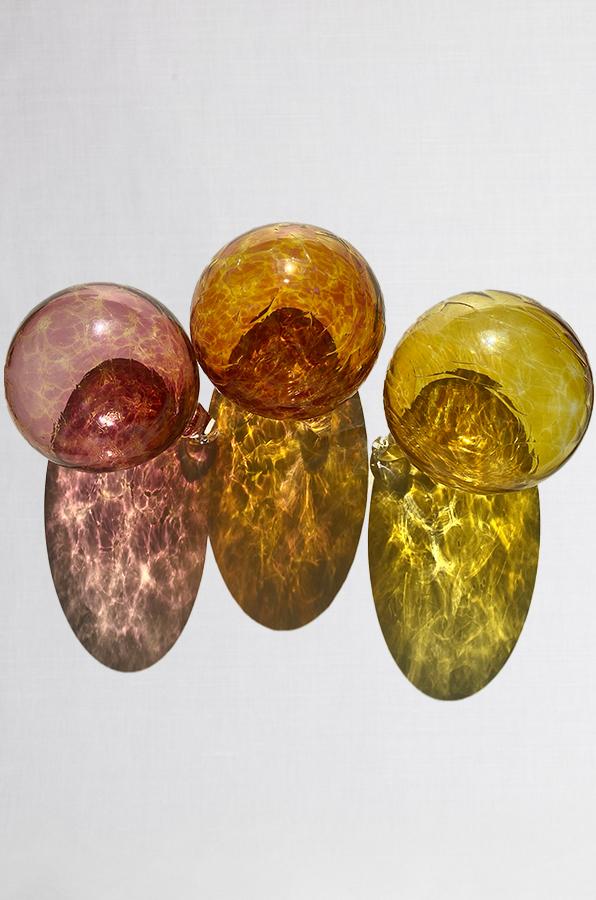 set of three hand blown glass ornaments in pink orange and yellow