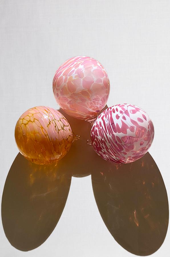 set of three hand blown glass ornaments in peach pink and mauve