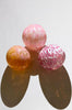 set of three hand blown glass ornaments in peach pink and mauve
