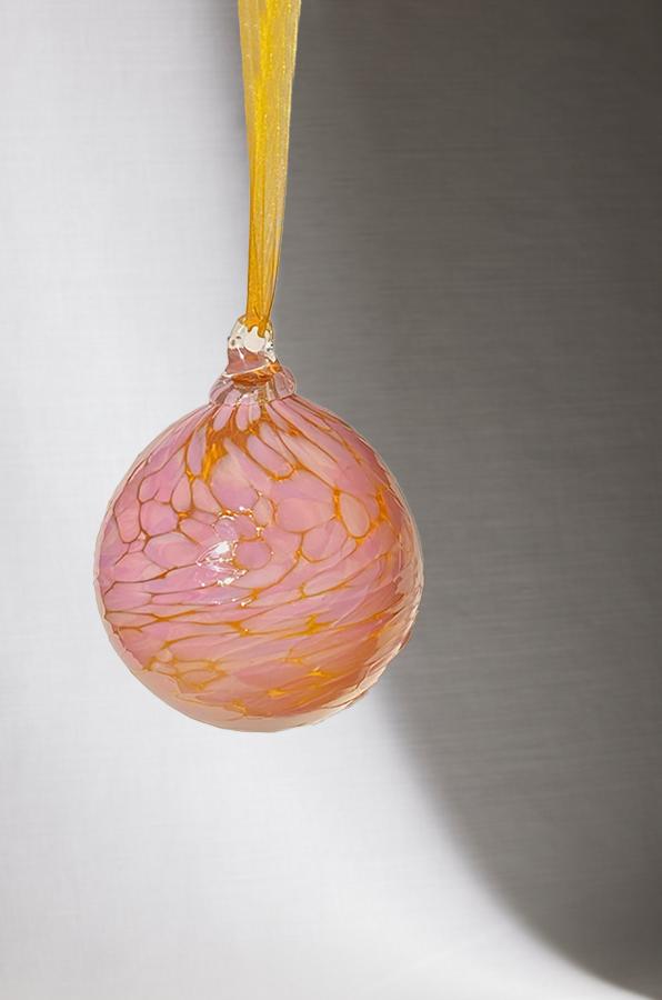 hand blown glass ornament with pink and orange speckle pattern