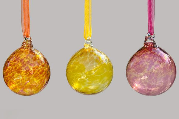set of three hand blown glass ornaments in orange yellow and pink