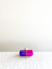 pink and purple glass christmas ornament shaped like a capsule with chill pill written on side alternate view