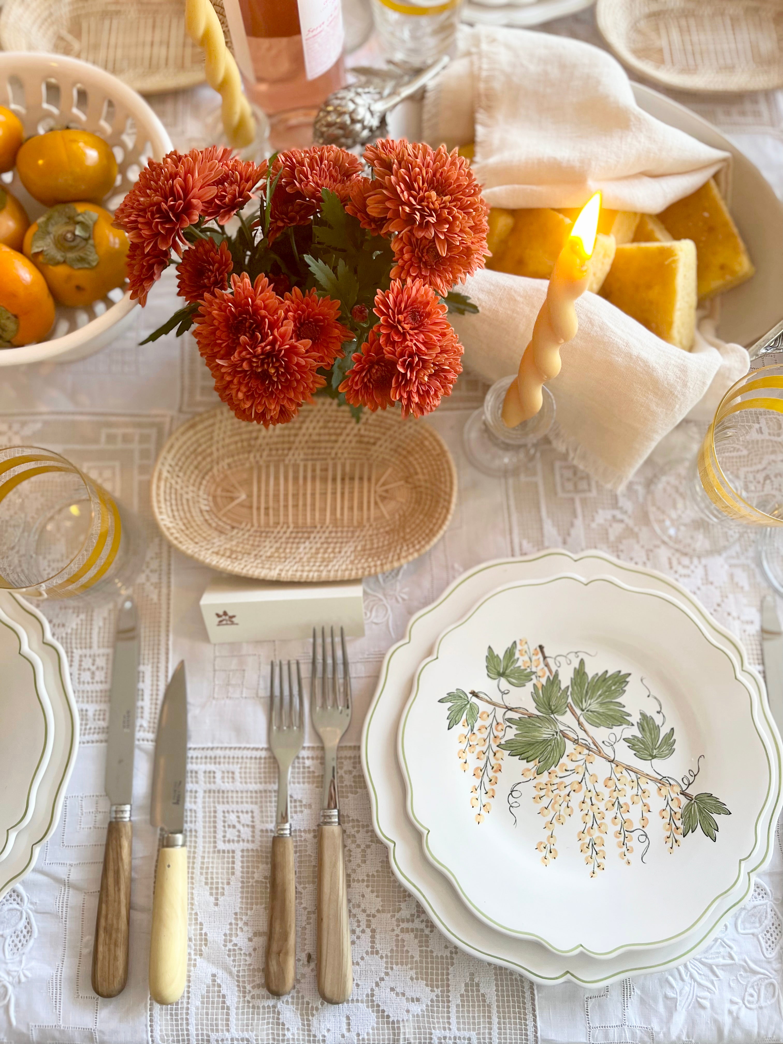 charger plate with green leaves and currants with place setting