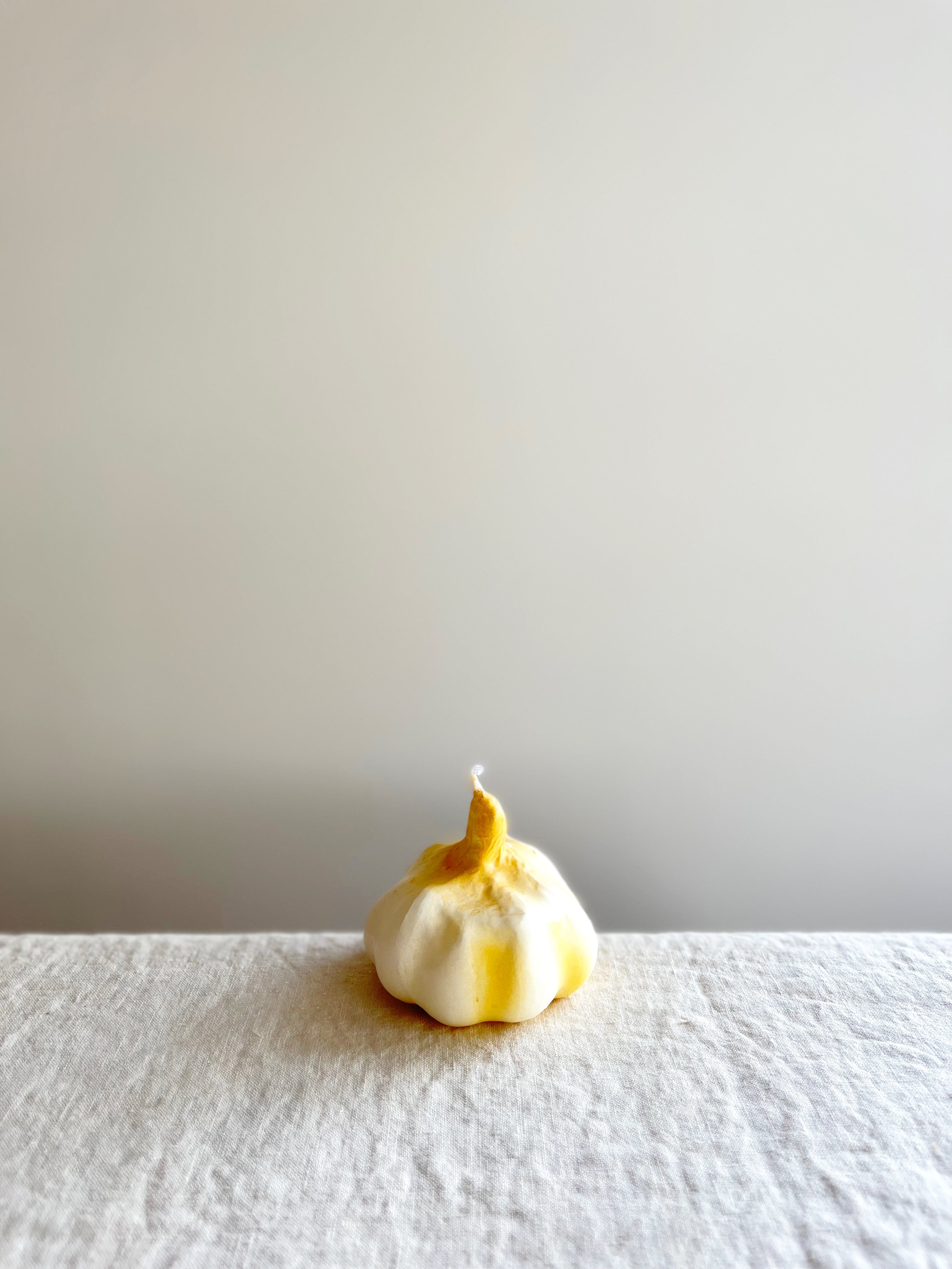 cereria introna garlic shaped paraffin candle on white table