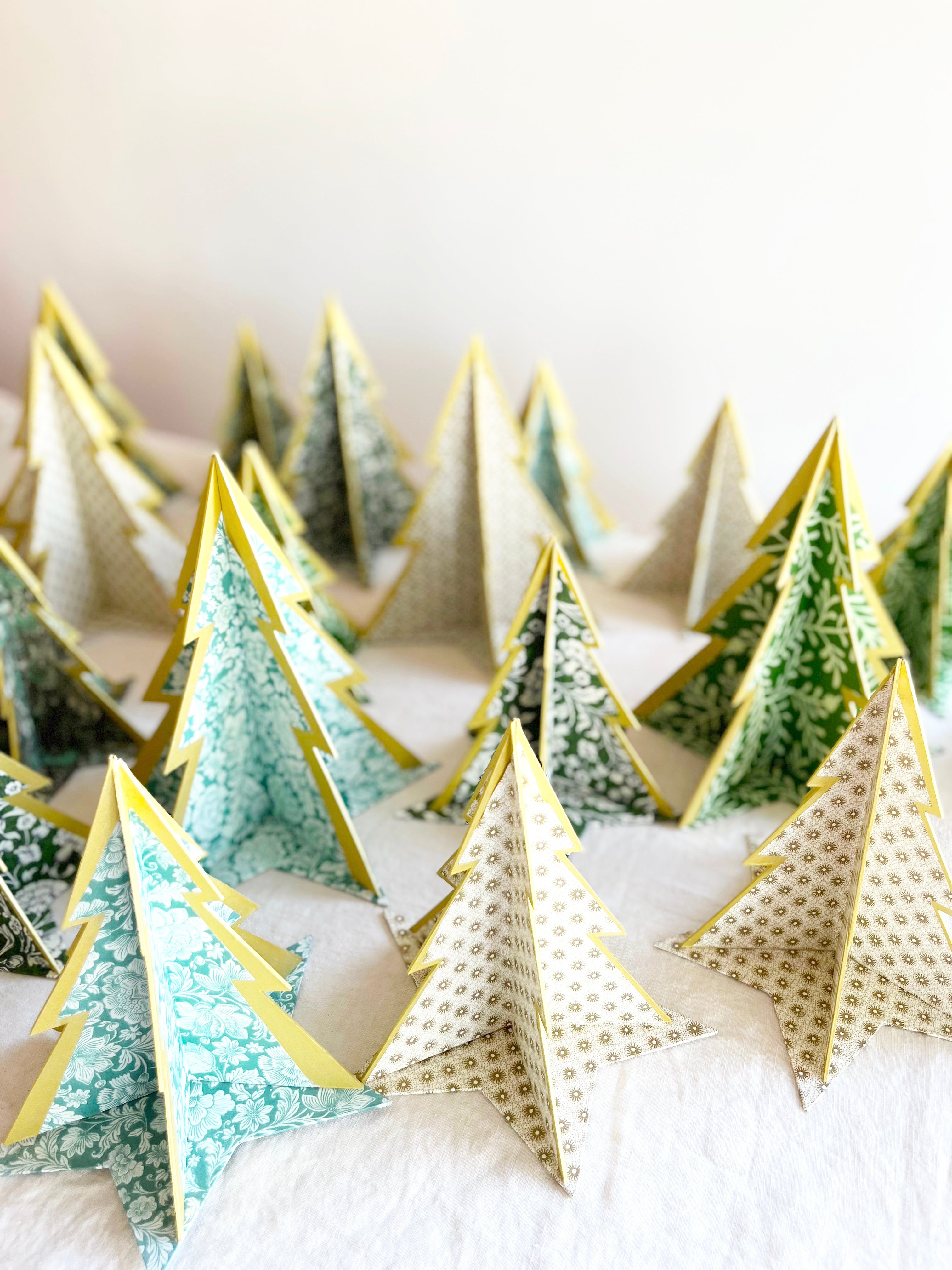 decorative paper Christmas tree stands with gold oval pattern on white table