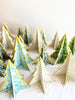 decorative paper Christmas tree stands with gold oval pattern on white table