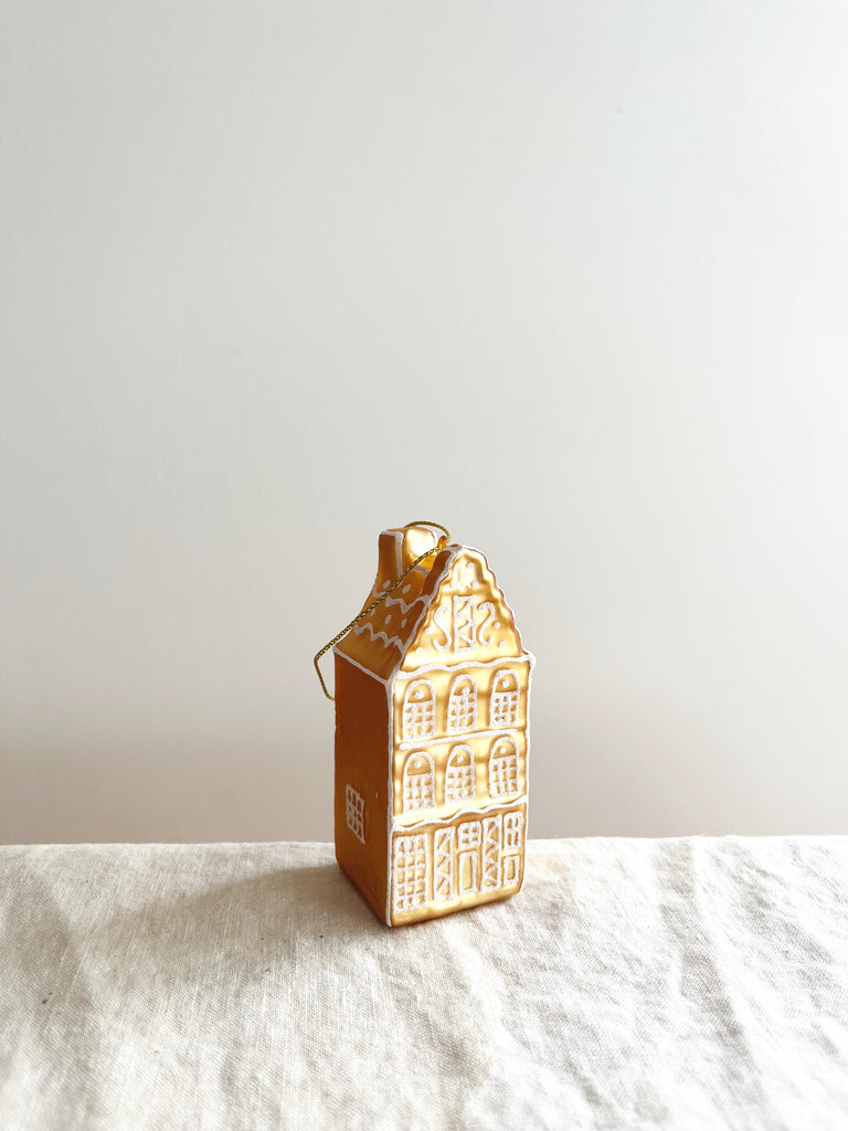 glass christmas ornament shaped like gingerbread house angled view