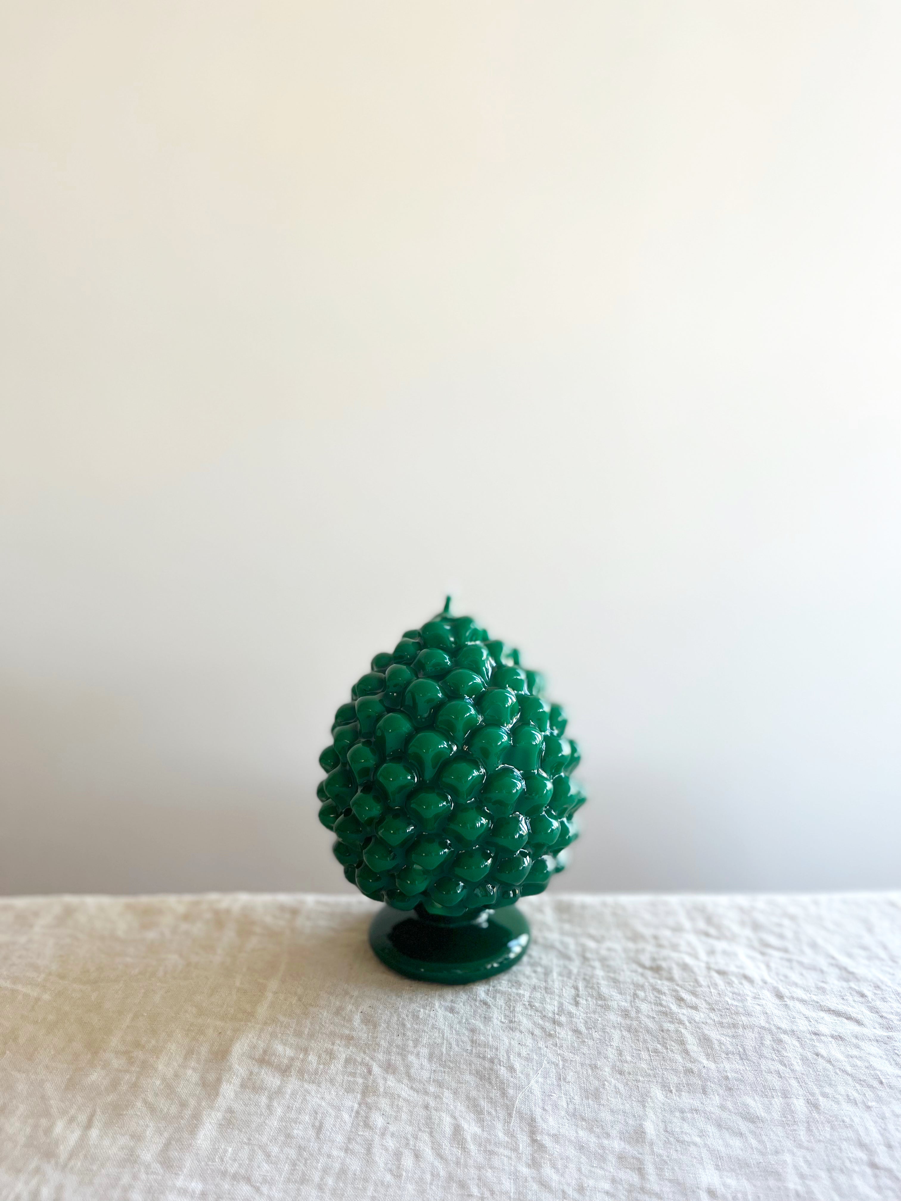 cereria introna pinecone paraffin wax candle green on white linen